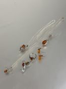 A collection of white metal and silver amber set jewellery including a pair of cube earrings,