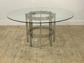 Merrow Associates, a 1970's dining table, the circular plate glass top raised on chrome box