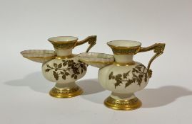A pair of 19thc Royal Worcester ivory jugs with flared spout, ribbed body, gilt and thistle leaf