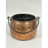 A late 19thc copper cooking pot or log bin of out swept design with folded lip and wrought iron loop