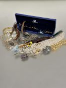 A collection of costume jewellery including a Swarovski bracelet in fitted case, paste pearl