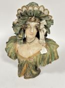 A 19thc Bohimia Turn Teputz porcelain bust of a lady with lace beribboned bonnet with green gilt