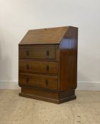 An Art Deco period oak bureau, the fall front opening to a fitted interior, above three drawers,