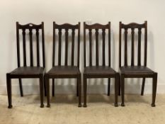 A set of four oak dining chairs, early 20th century, each with a faux leather upholstered seat