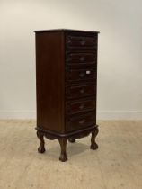 A tall hardwood chest of 18th century inspiration, the six drawers with floral carved decoration