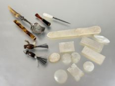 A collection of nine 19thc Chinese shell gaming tokens, an oval carved panel and paper knife all