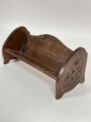 A Edwardian walnut Art and Crafts style book trough with relief carved scrolling design H x 15cm L x