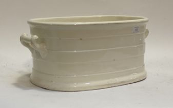 A Victorian style white ceramic footbath, with scroll handle to each end, 47cm.