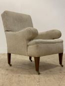 An upholstered drawing room armchair, early 20th century and later, covered in a natural linen, on