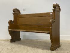 A late Victorian stained pine pew / bench, the panel seat and back on scroll carved panel end