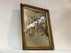A 20thc decorative mirror in a gilt composition frame. (a/f) (57cmx45cm)