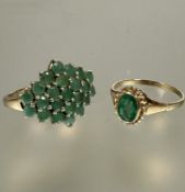 A 9ct gold oval emerald ring set in rope pattern border, O and a 9ct gold emerald cluster ring set