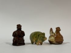 A collection of 19thc Scottish Pottery money boxes or banks, one of treacle glazed seated man (h-