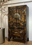 A late 19th century Chinese marriage cabinet, the lacquered exterior with typical chinoiserie