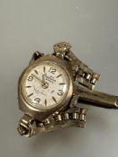 A ladys Vintage Bertina 9ct gold wrist watch with silvered dial and baton and Arabic numerals on 9ct