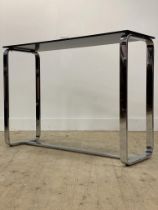 A modern consul table, the rectangular black glass top raised on twin end chrome supports.