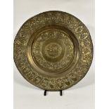 A early 20thc Indian brass embossed circular tray, the center with charioteer and nobleman