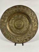 A early 20thc Indian brass embossed circular tray, the center with charioteer and nobleman