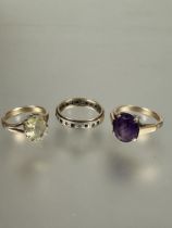 A yellow metal oval pale citrine set dress ring, P, a yellow metal oval amethyst set dress ring,