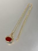A modern 9ct gold revolving seal pendant in Art Nouveau style mount set blood stone and carnelian
