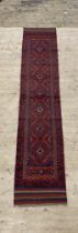 A Meshwani runner rug of typical design 281cm x 57cm