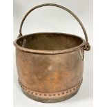 A large late 19thc copper studded log bin with folded rim and wrought iron loop handle and