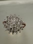 A 9ct gold diamond cluster ring set four radiating rows, set approximately 51 diamond points, D 1.