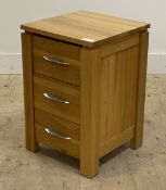 A contemporary oak bedside chest fitted with three drawers. H62cm, W40cm, D40cm.