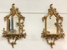 A pair of gilt composition framed girandole mirrors in the Chippendale taste, each with