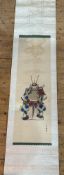 A Japanese late 19th/ early 20thc wall scroll with seated figure of a Samurai with silk border and