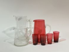 A collection of glass ware comprising a tall glass pitcher with bubble handle (h-24cm), a pitcher