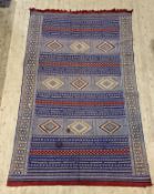 A North African / Moroccan flat weave rug, the blue field of lineal design with three panels