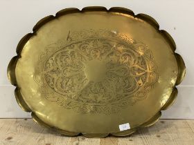 An eastern brass tray with scalloped edge. W68cm.