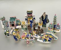 A collection of Chinese pottery miniature figures including a fisherman, scholar, pagodas,