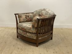 Ercol, a vintage armchair, with spar back and sides, squab cushions, raised on turned supports.