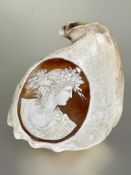 A late 19thc Conch shell with Italian Romanesque style cameo depicting a female with long flowing