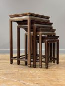 A Chinese rosewood quartetto nest of tables, mid 20th century, each panelled top inlaid with