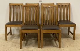 A set of six contemporary ash dining chairs, with brown leather upholstered seats, raised on