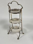 A 1920s Epns three tier cake stand with arched handle to top at beaded rim dishes raised on twin