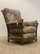 Ercol, a vintage high back armchair, with spar back and sides, squab cushions, raised on turned