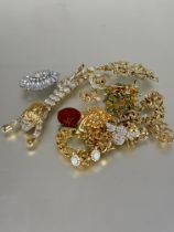 A collection of costume jewellery including an impressive paste set male lion articulated brooch L x