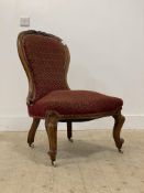 A Victorian walnut upholstered spoon back slipper chair, standing on cabriole front supports with