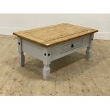 A modern pine coffee table, the rectangular top with moulded edge fitted single frieze drawer with