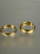 A 22ct gold wedding band L and a 22ct gold wedding band cut 7.35g (2)