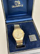 A Vintage gents Seiko gilt metal quartz water resistant wristwatch with baton hour markers and day/