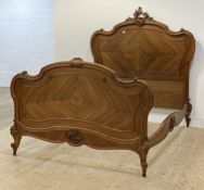 A Louis XV style French walnut double bed frame, late 19th century, the headboard of scrolling
