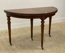 A mid 19th century mahogany demi-lune fold over console / dining table, the circular top supported