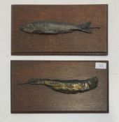 A pair of early 20th century cast bronzed metal fish, mounted on wall plaques. L36cm.