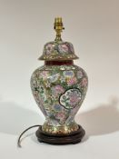 A modern Chinese Famille rose style on gold background baluster shaped table lamp raised on a
