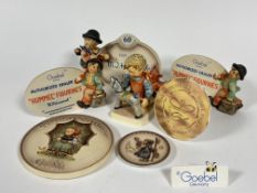 A collection of Hummel shop display signs including 1935-199, authorized dealer, Goebel , Collectors